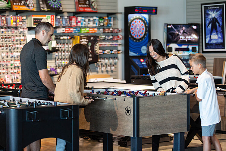 family playing foosball at Billiard Factory store