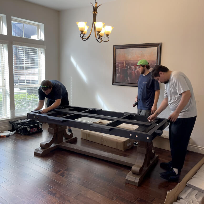 Billiard Factory workers installing a pool table